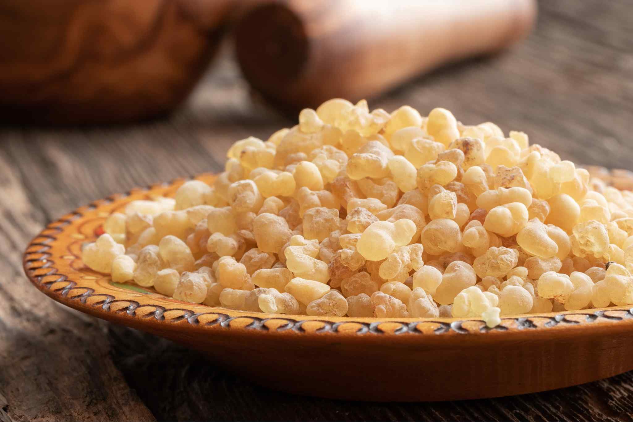 Natural Boswellia resin displayed on a wooden plate. Boswellia serrata, also known as Indian frankincense, contains boswellic acids studied for their potential role in supporting joint health and mobility.