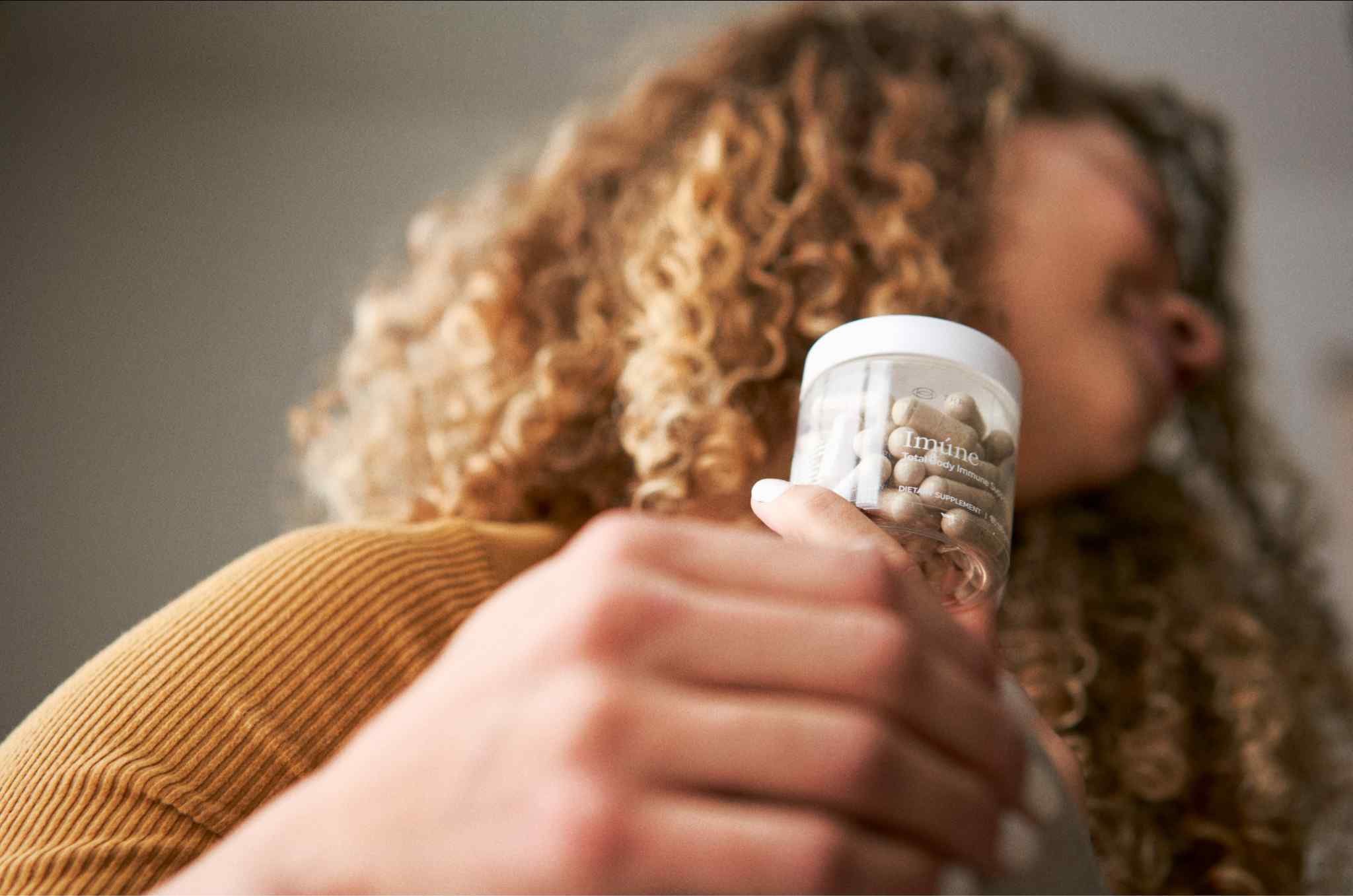 Close-up of an Imúne Total Body Immune Support supplement bottle containing capsules formulated to support the body’s natural immune defenses.