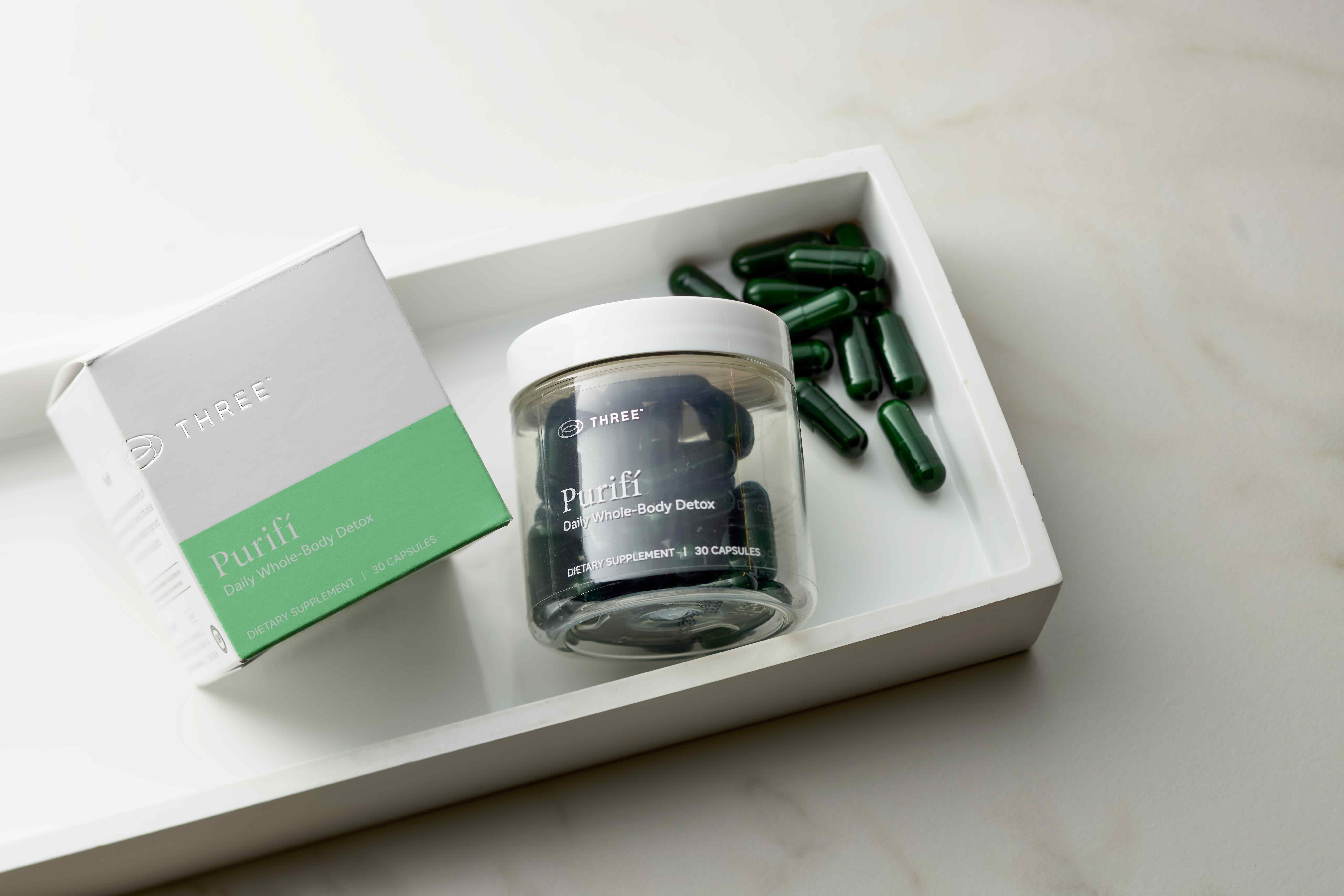 Purifí whole-body detox supplement is shown with its packaging and green capsules, highlighting a science-backed detox supplement designed to support natural detoxification pathways.