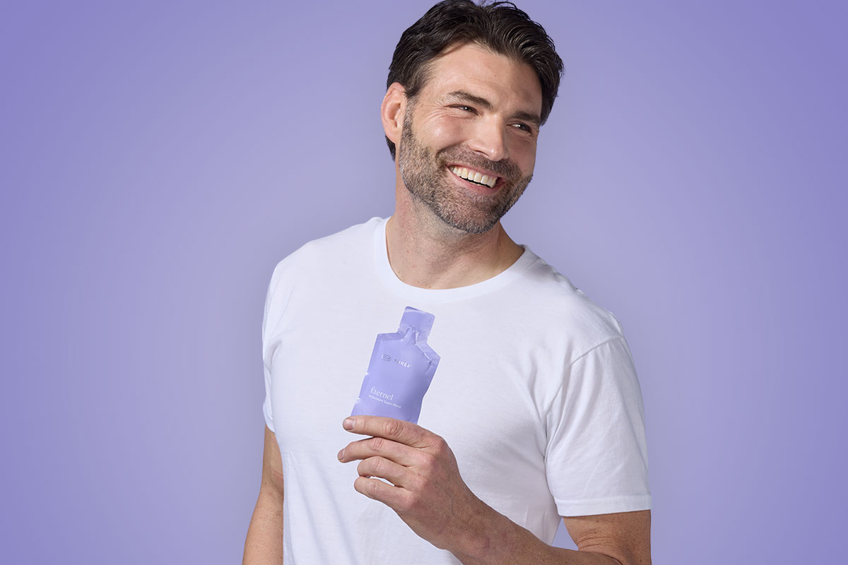 man holding a pouch of Éternel by THREE with powerful antioxidants and CoQ10 for heart health