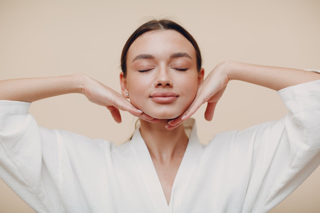 A woman who just experienced the benefits of a high-end skincare luxury moisturizer. 